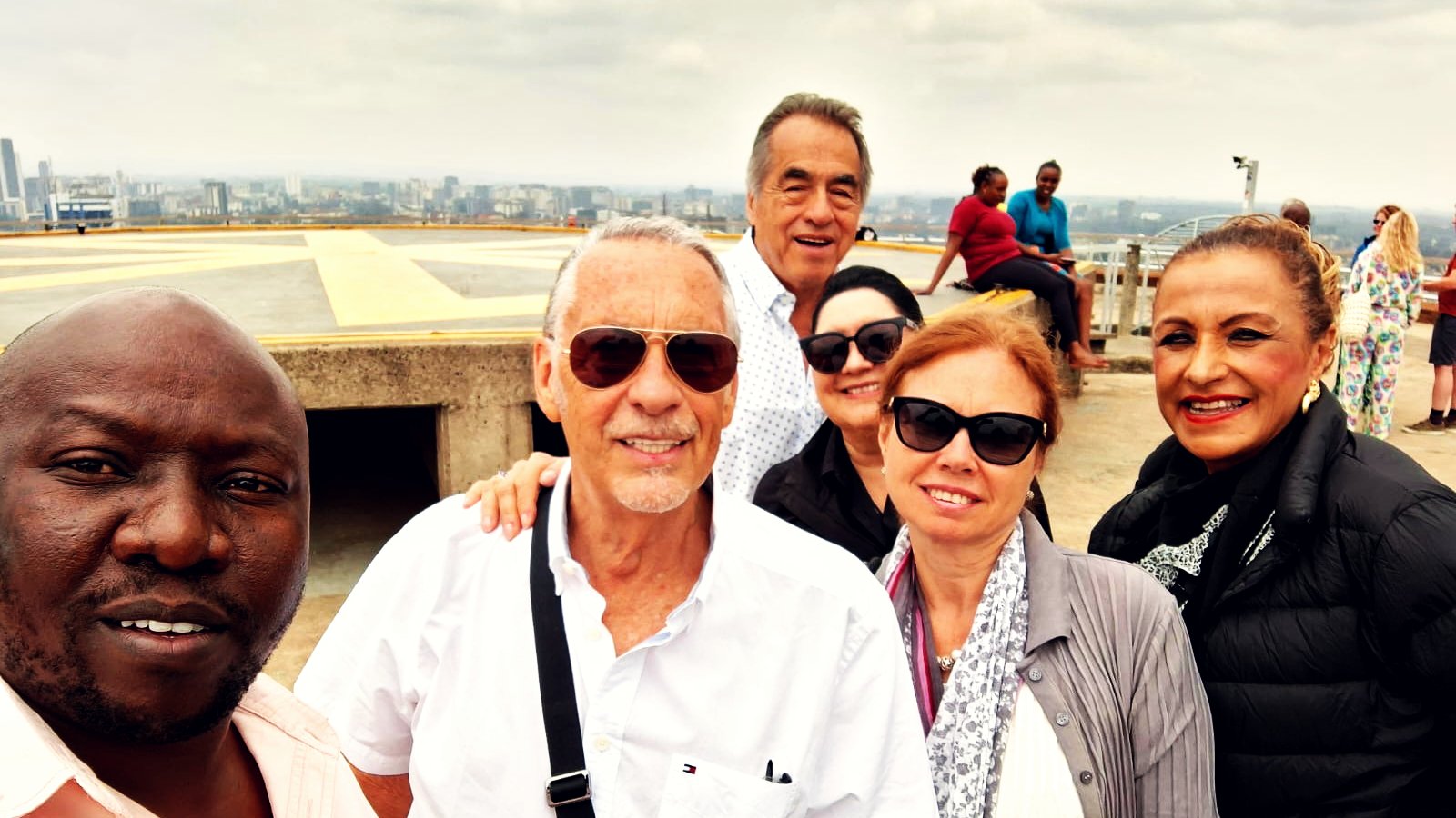 HGS guide with international guests on a rooftop helipad above the Nairobi skyline