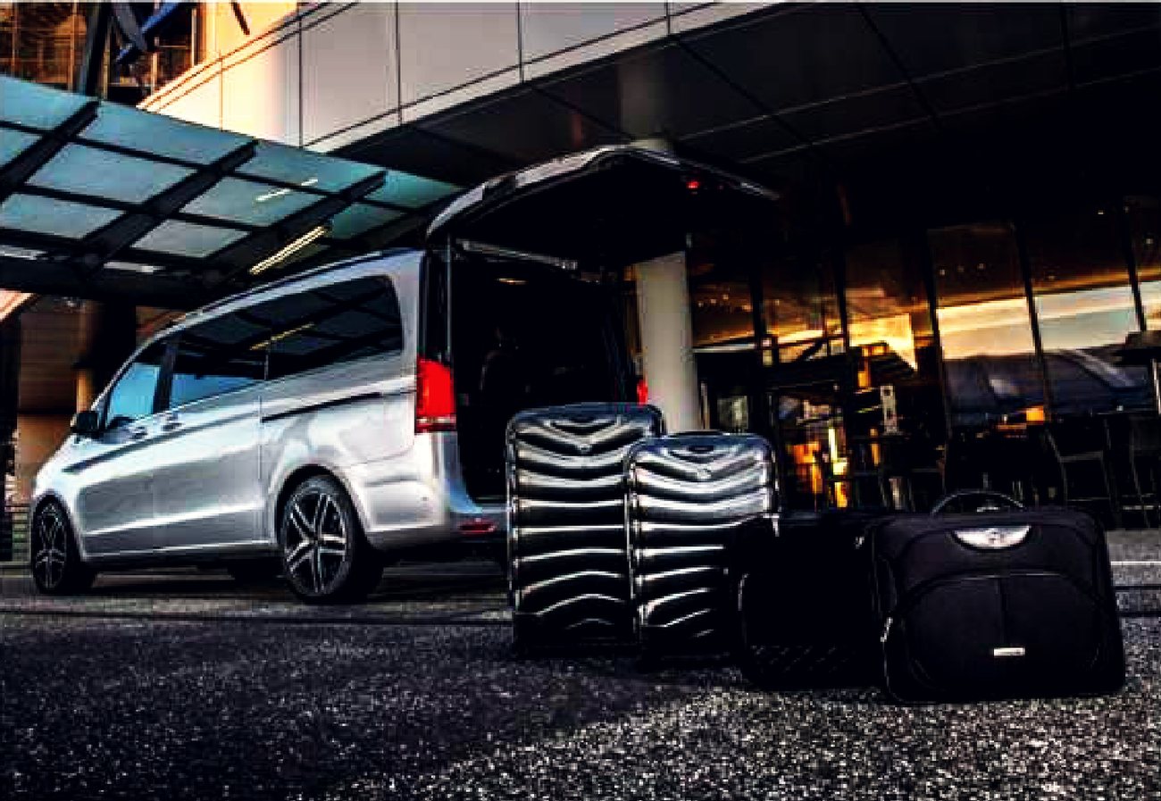 Executive van with luggage loaded at a hotel